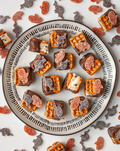 Sour Punch Pretzel Sandwiches filled with edible cookie dough and topped with Bats & Pumpkins Halloween Candy