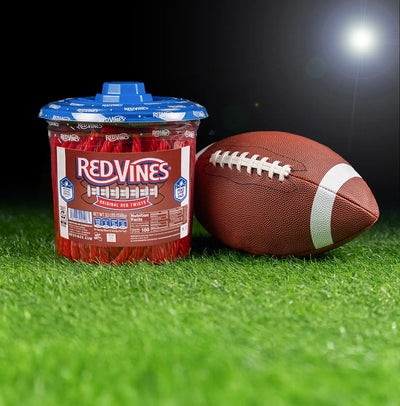 Red Vines Original Red Licorice Candy Twists 3.5lb Jar in limited-edition football graphics next to a football
