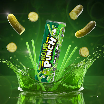 Sour Punch Pickle Straws Tray and candy surrounded by flying pickle slices and a splash of pickle juice