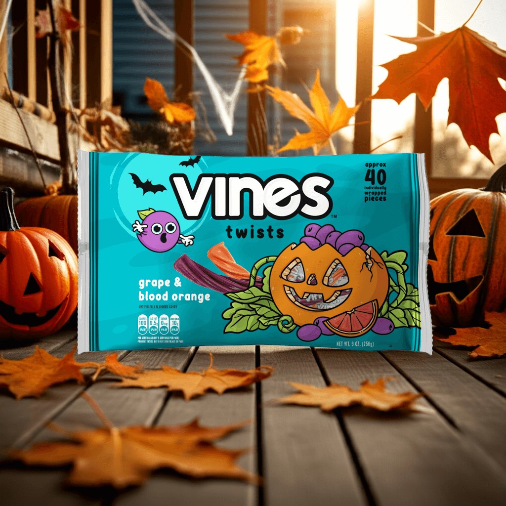 Vines twists packaging with Halloween-themed design on a wooden surface with pumpkins and leaves.
