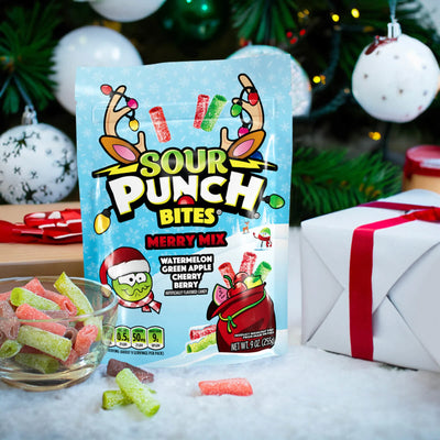 SOUR PUNCH Merry Mix Bites holiday candy next to gifts and decorated tree