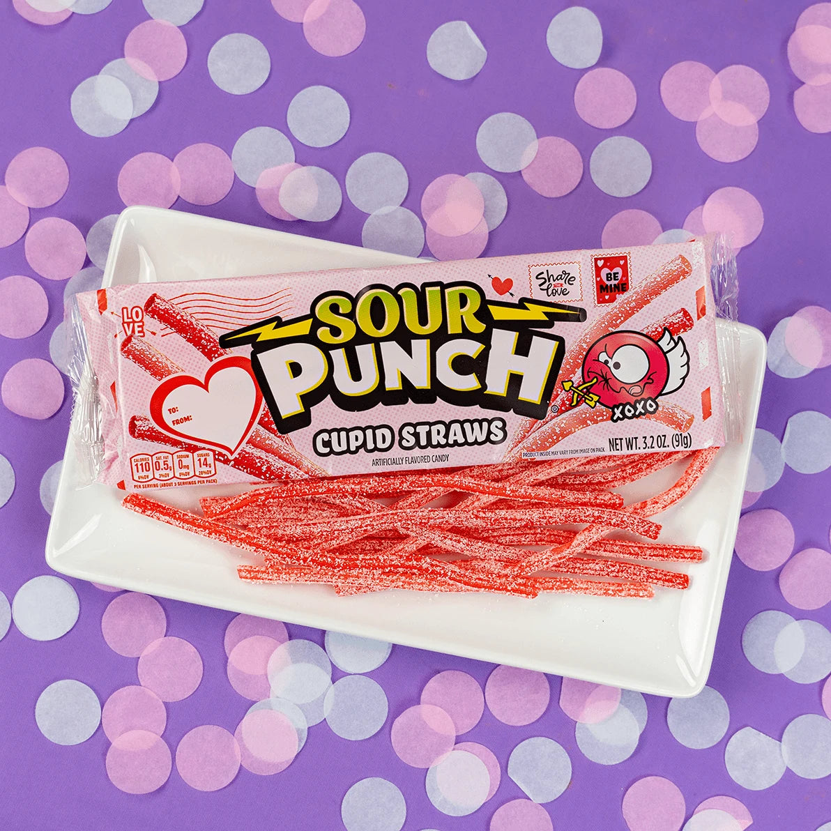 SOUR PUNCH Cupid Straws valentine candy trays on pink tablecloth with a pen