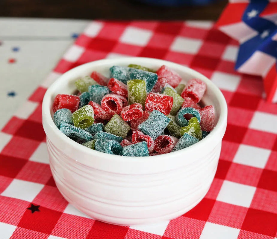 Bowl of Sour Punch Assorted Mini candy on a red and white checkered cloth