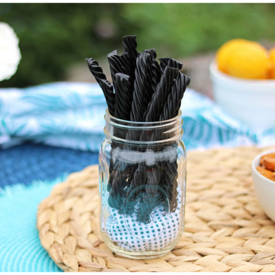 Red Vines Black Sugar Free Licorice Twists in a jar near other poolside snacks