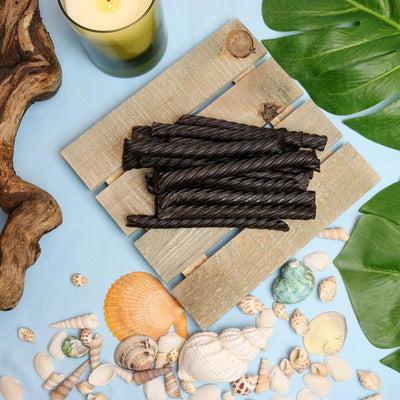 Red Vines Black Licorice Jumbo Twists in a summer scene with seashells and beach wood