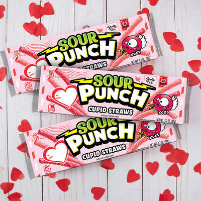 SOUR PUNCH Cupid Straws valentine candy trays on white table with red cut out hearts