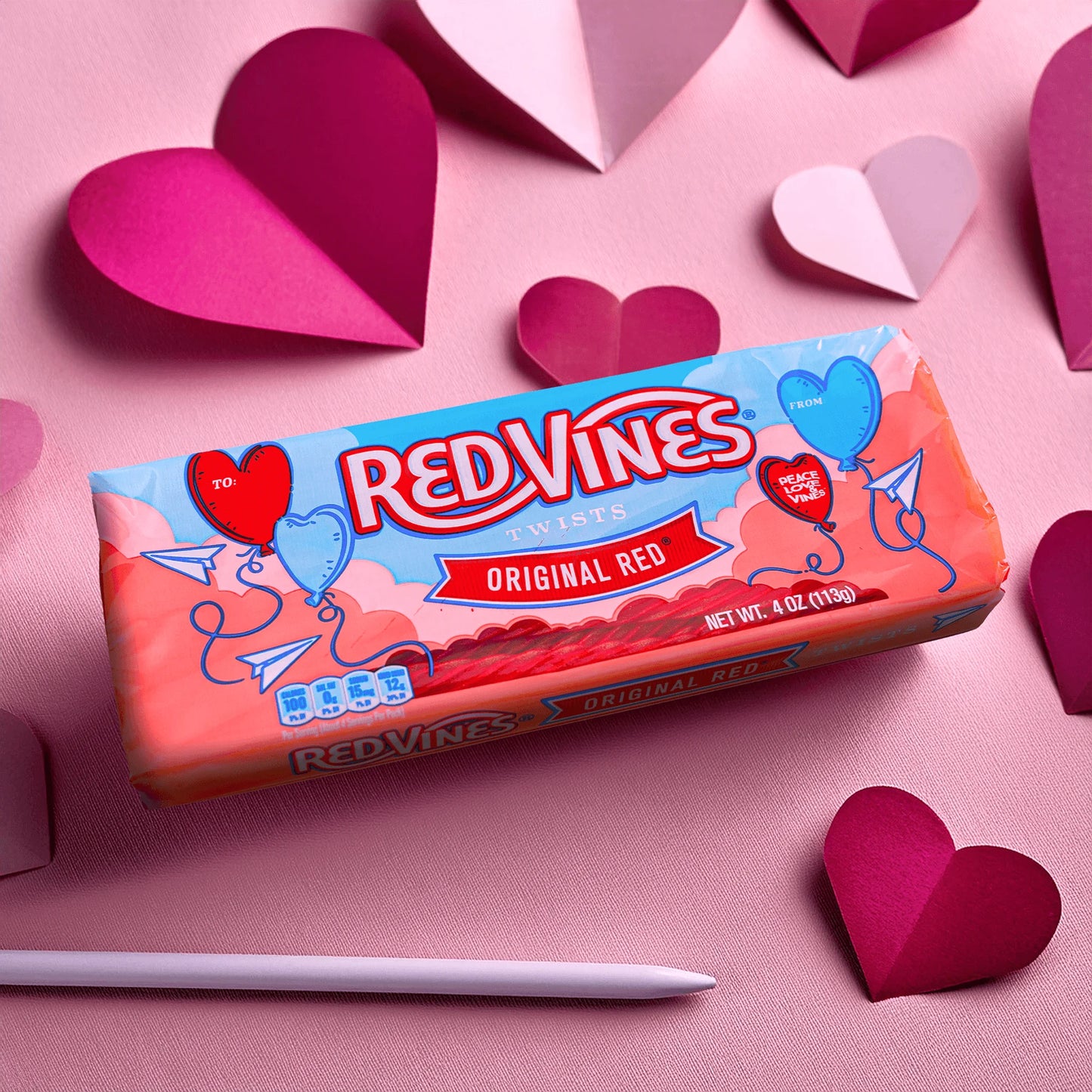 Red Vines Original Red Valentines Day Candy Tray on a pink background with cut out hearts
