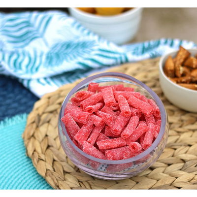 Sour Punch Strawberry Bites in a bowl near other poolside snacks