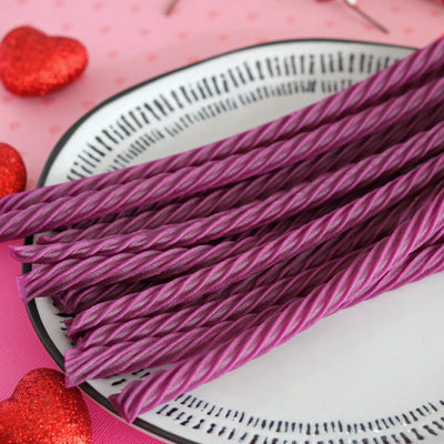 RED VINES Grape Licorice Twists on a white plate surrounded by red sparkle hearts