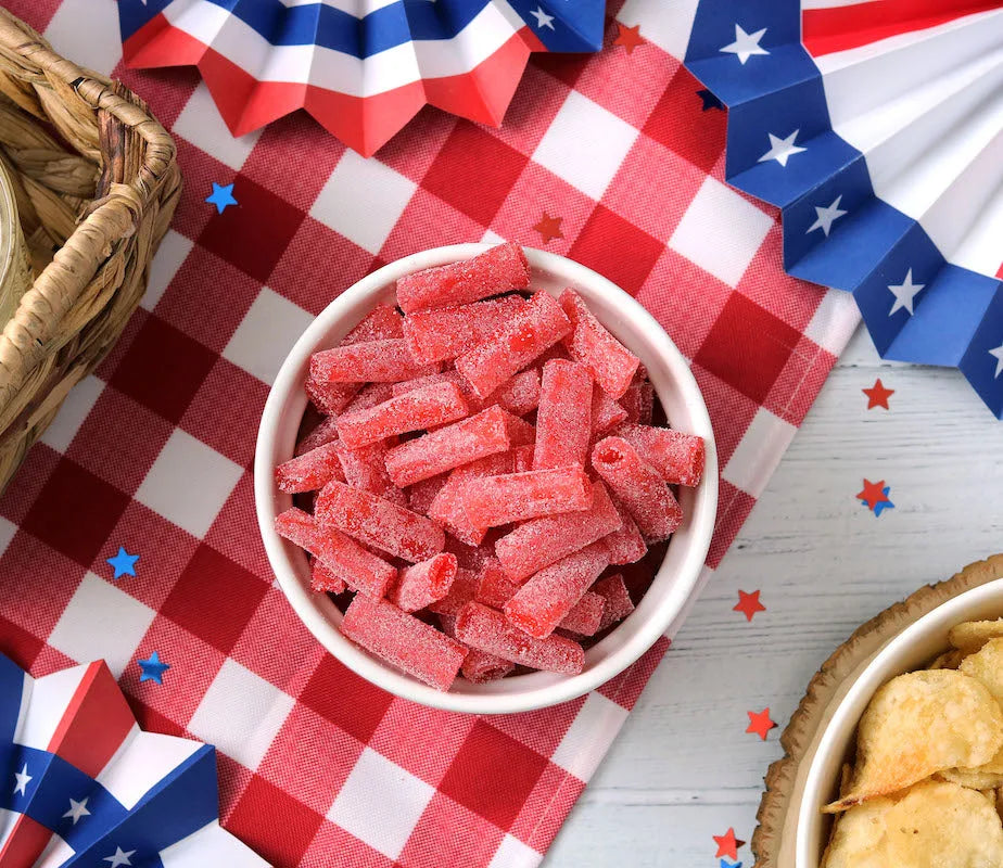 Sour Punch Strawberry Bites on a picnic table with patriotic decorations
