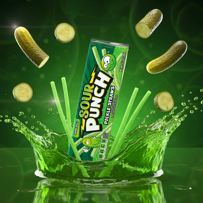Sour Punch Pickle Straws Tray and candy surrounded by flying pickle slices and a splash of pickle juice