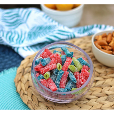 Sour Punch Bites Assorted Flavors in a bowl near other poolside snacks