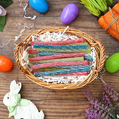 Sour Punch 6in Individually Wrapped Candy Twists in an Easter basket surrounded by confetti and plastic eggs