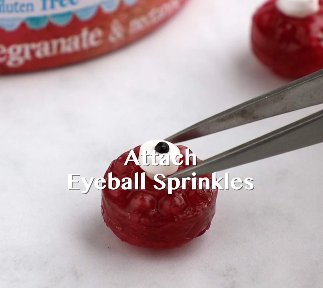 Attach eyeball sprinkles to the candy eyes