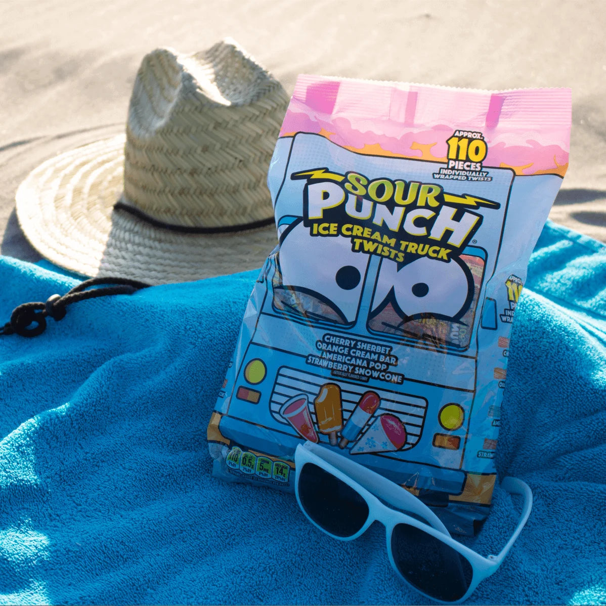 SOUR PUNCH Ice Cream Truck Twists bag on a beach blanket on a sunny day