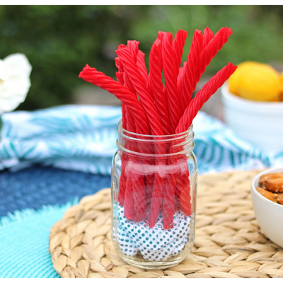 Red Vines Original Red Licorice Twists in a jar near other poolside snacks