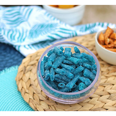 Sour Punch Bites Blue Raspberry Candy in a bowl near other poolside snacks