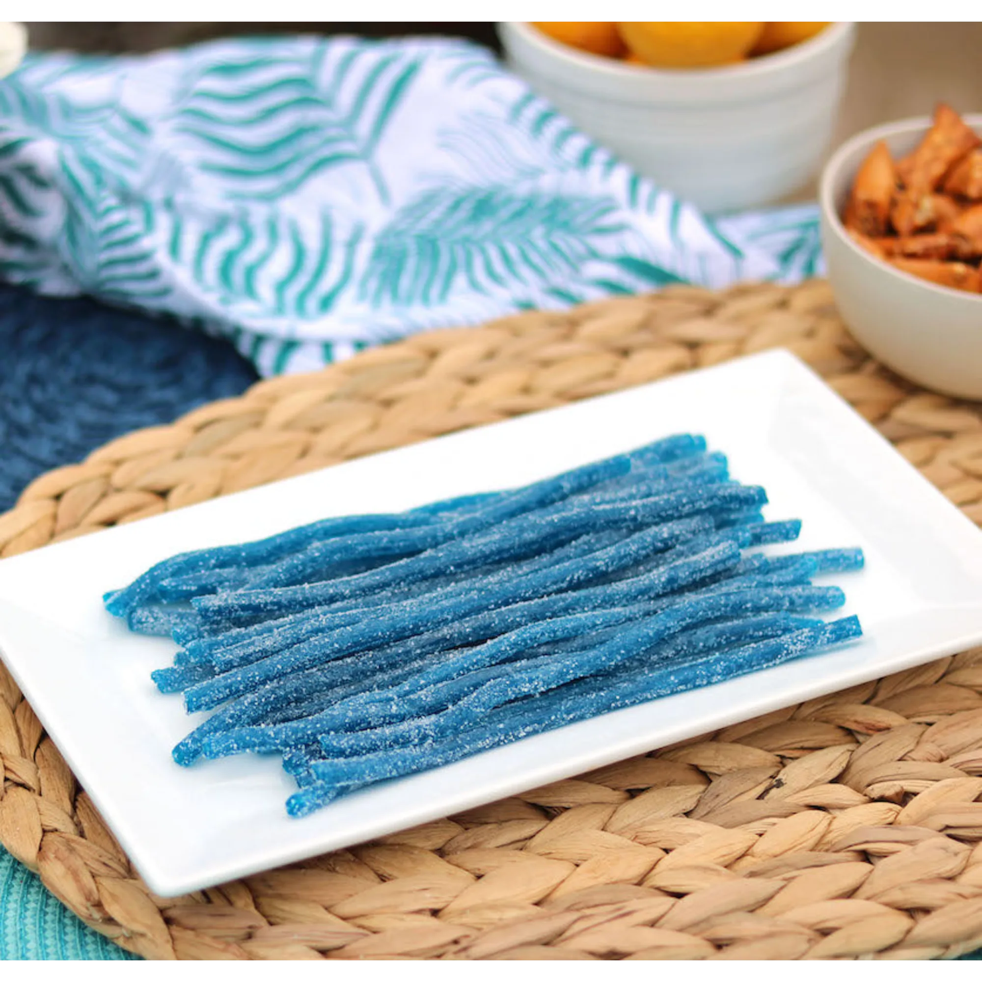 Sour Punch Blue Raspberry Straws Candy on a platter near other poolside snacks