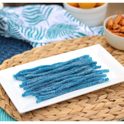 Sour Punch Blue Raspberry Straws Candy on a platter near other poolside snacks