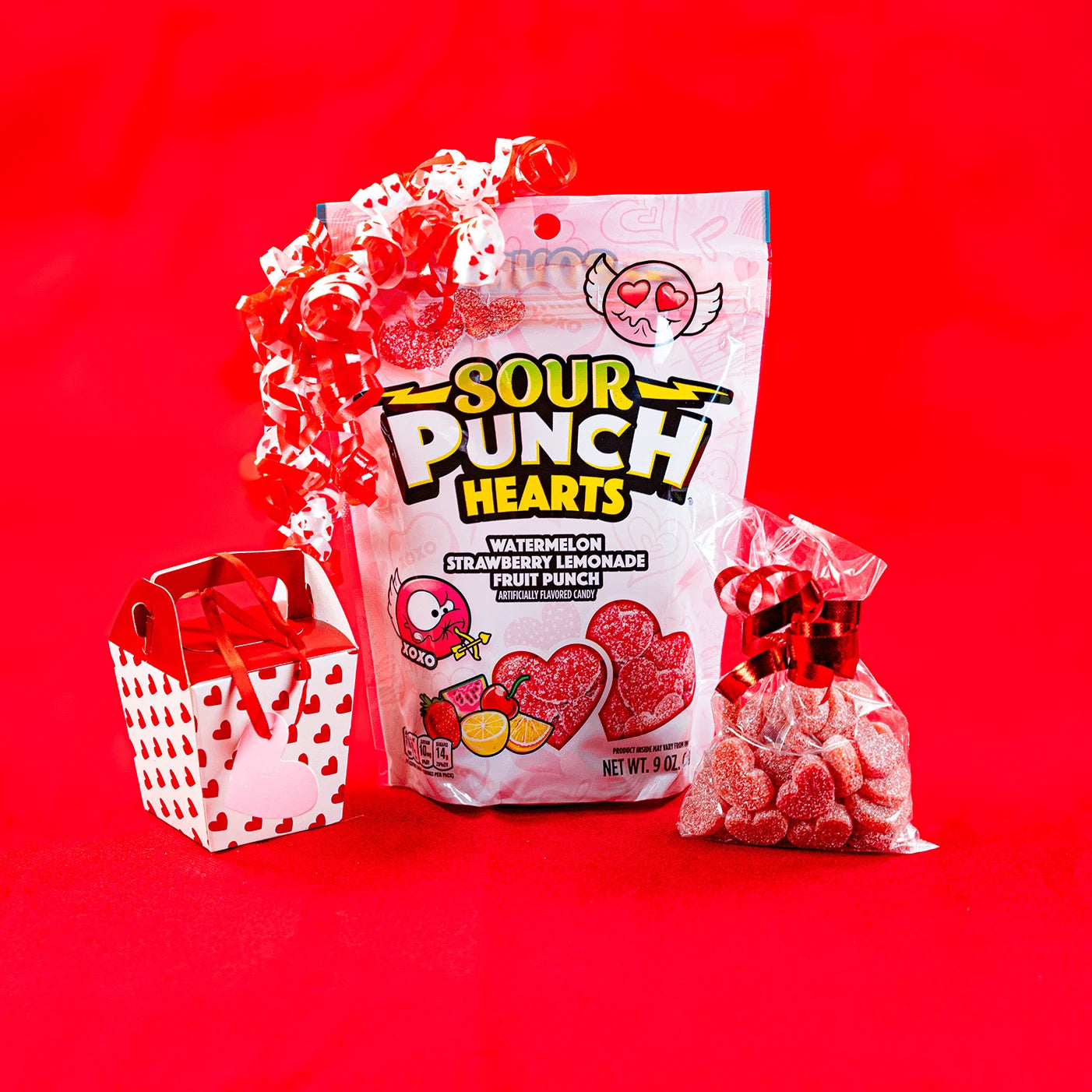 Sour Punch Hearts Valentine's Day Candy bag with a bow, Valentine's gift box and a gift bag of sour candy hearts