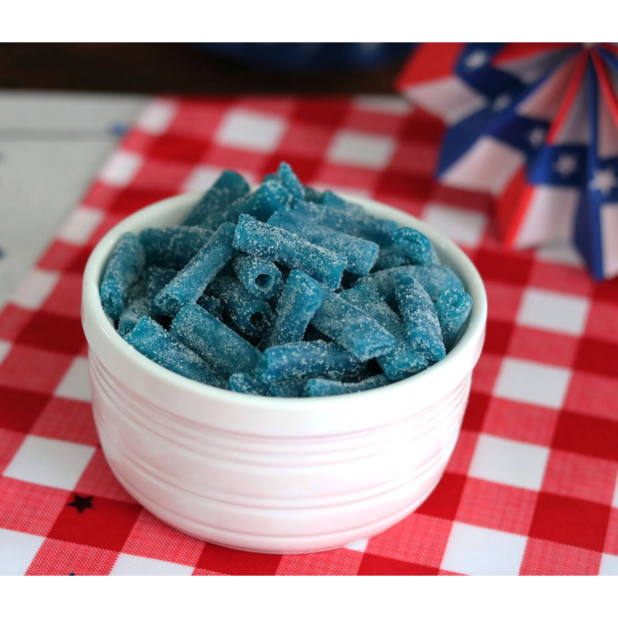 Sour Punch Bites Blue Raspberry Candy on a picnic table with patriotic decorations