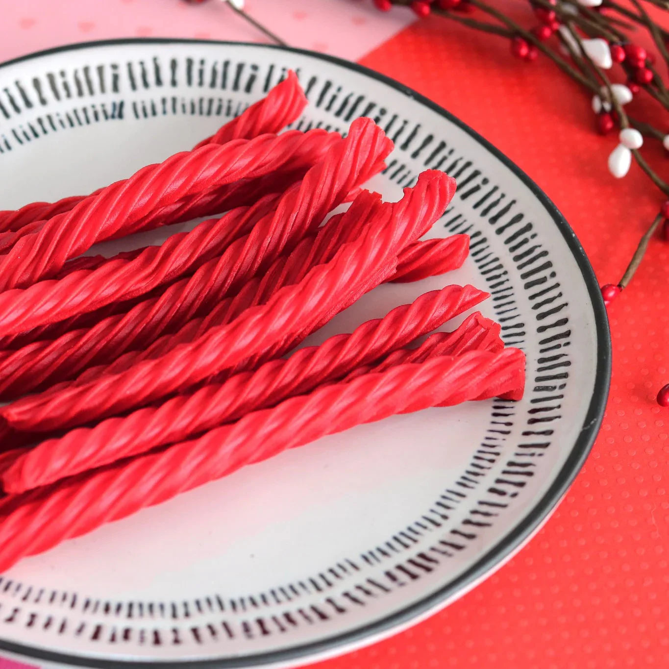Red Vines Original Red Valentines Day Candy on a white plate surrounded by valentine decor