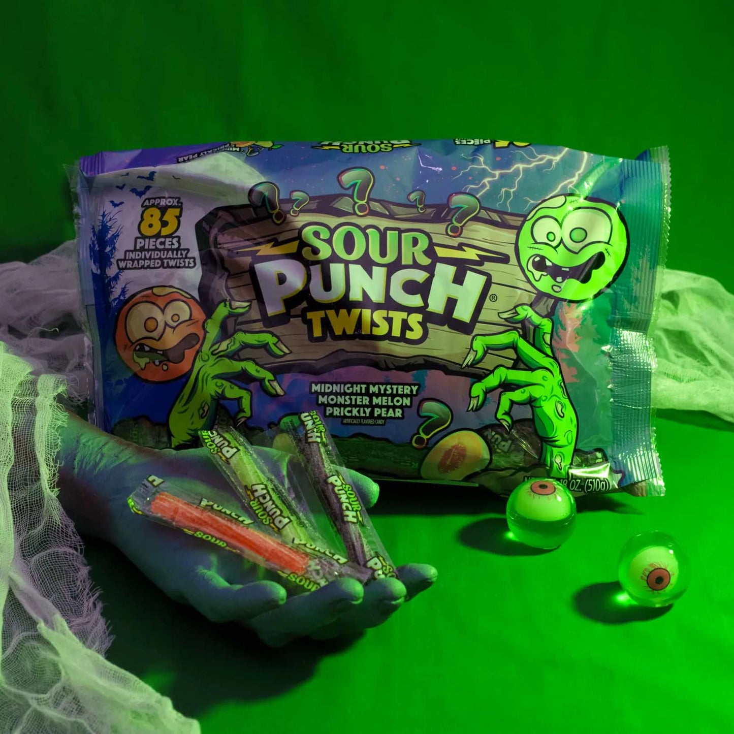 Sour Punch Individually Wrapped Halloween Candy Twists in a spooky scene with eyeballs and a monster hand