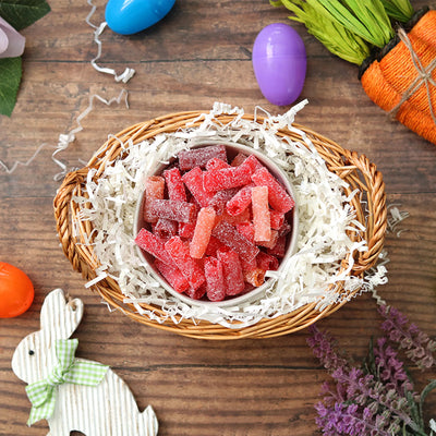 Sour Punch Rad Reds Bites candy in an Easter basket surrounded by confetti and plastic eggs