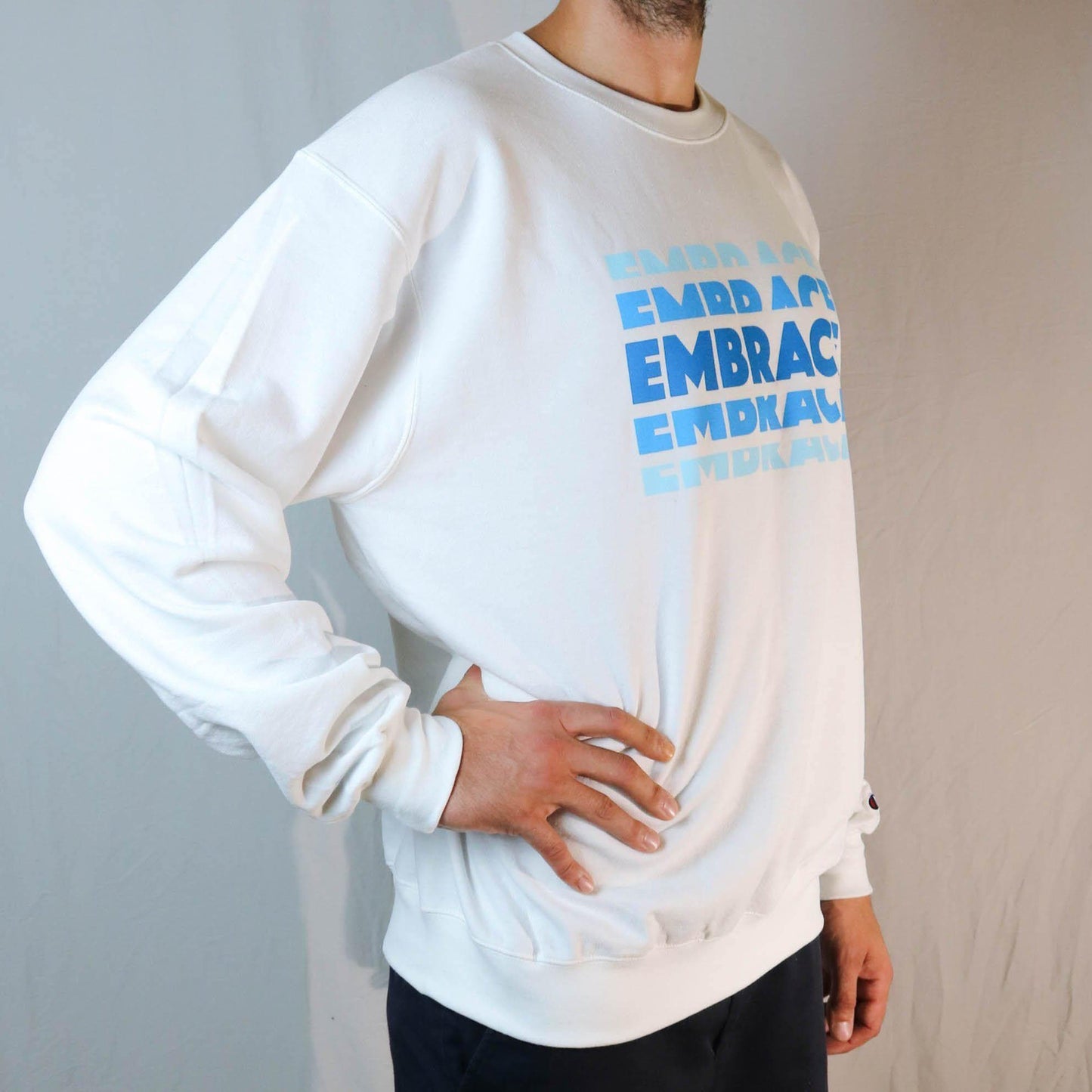 Side angle of white SOUR PUNCH Crewneck Sweatshirt with a relaxed fit Side angle of white SOUR PUNCH Crewneck Sweatshirt with a relaxed fit