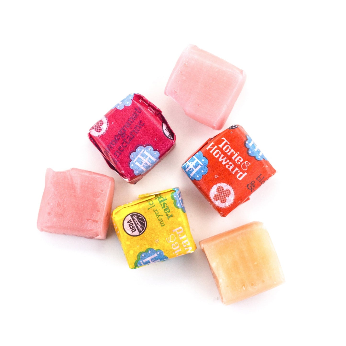 Chewie Fruities Pomegranate & Nectarine, Meyer Lemon & Raspberry, and Blood Orange & Honey candy fruit chews wrapped and unwrapped