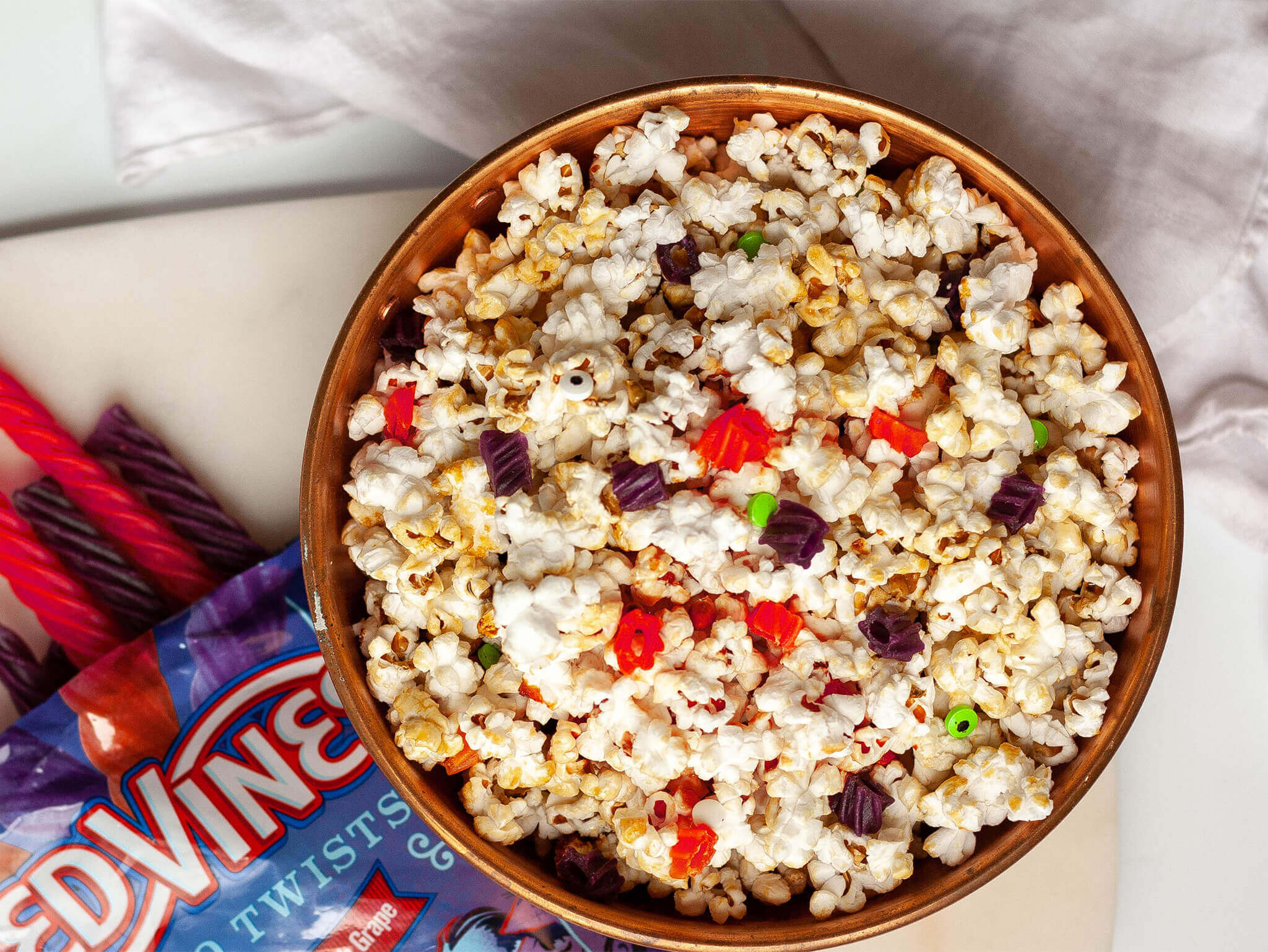 Popcorn mixed with Red Vines candy pieces