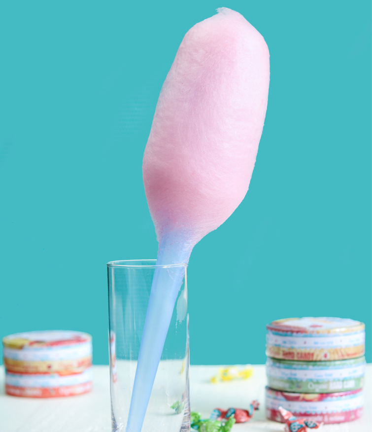 Pink Cotton Candy Stick standing next to Torie & Howard Hard Candy