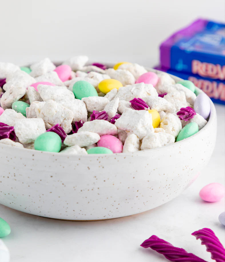 Easter mix of puppy chow, pastel almonds, and Grape Vines pieces in a bowl
