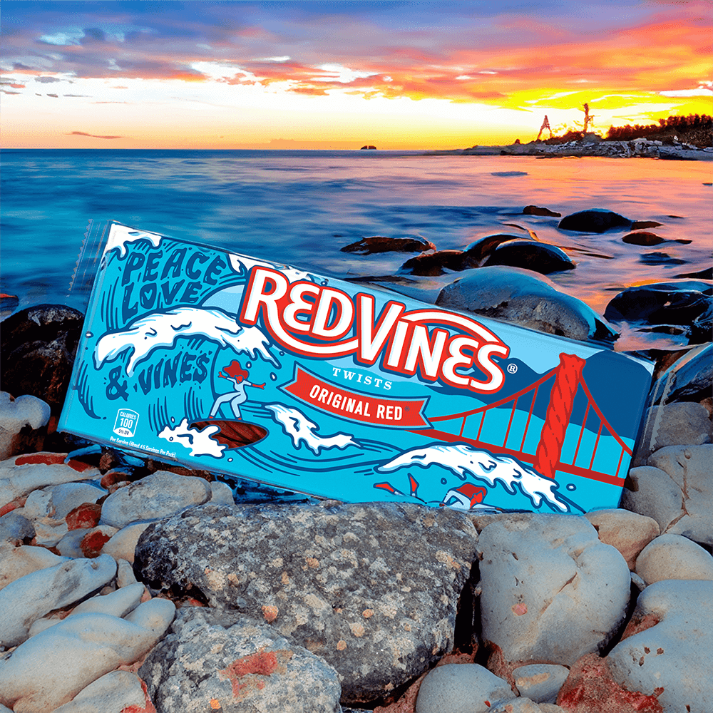Red Vines Peace, Love, & Vines Tray on a rocky beach during sunset