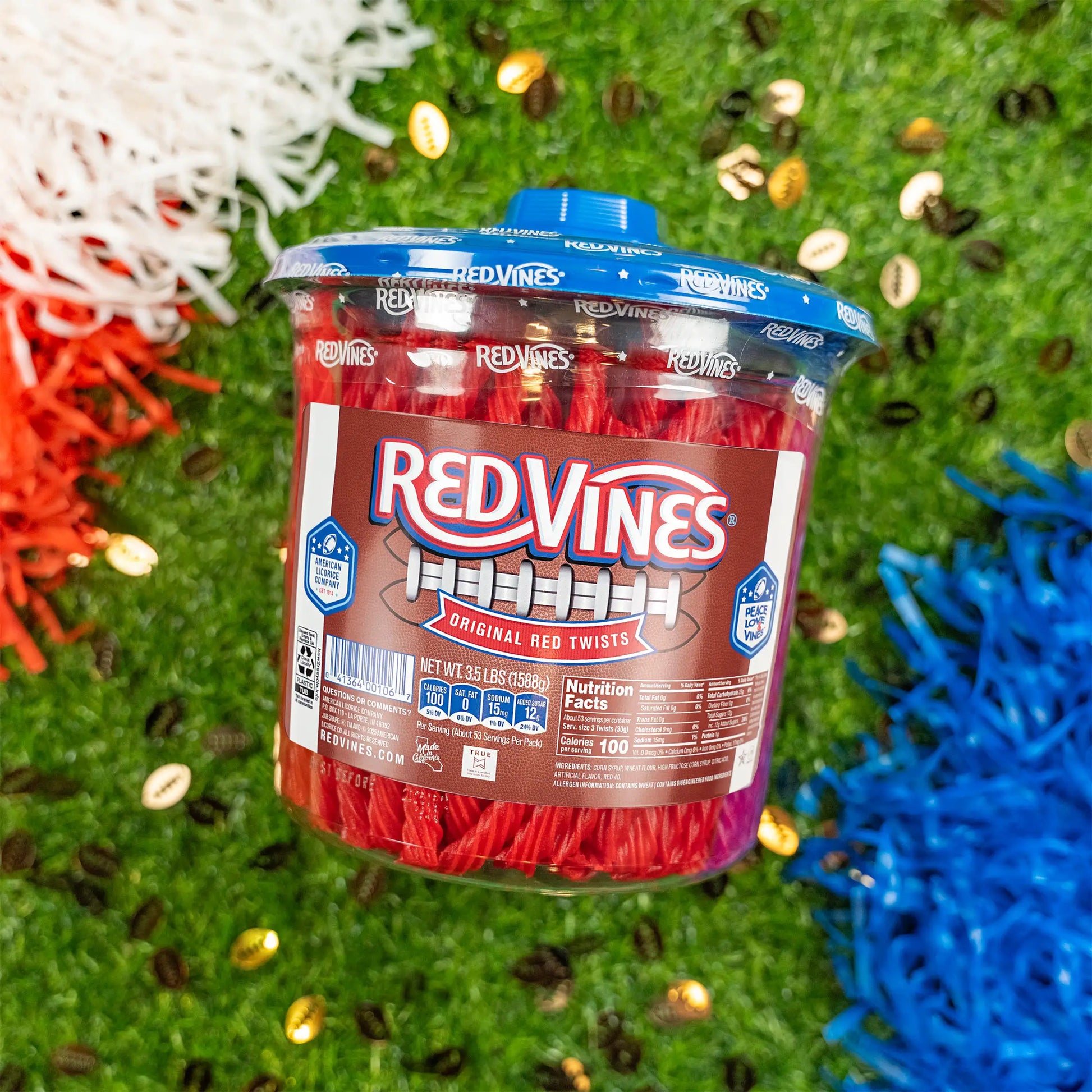 Red Vines Original Red Licorice Candy Twists 3.5lb Jar in limited-edition football graphics next to pompoms on a football field