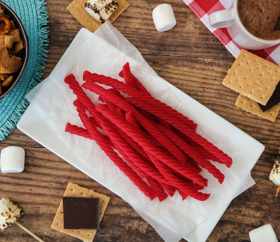 RED VINES Original Red Licorice Twists on picnic table with s'mores materials