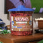 Front of Red Vines Original Red Licorice Twists 3.5lb Jar in limited-edition football graphics, sitting on a coffee table while the big game is on TV