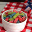Sour Punch Assorted Candy Bites summer candy in a bowl on top of an Americana-themed picnic table  