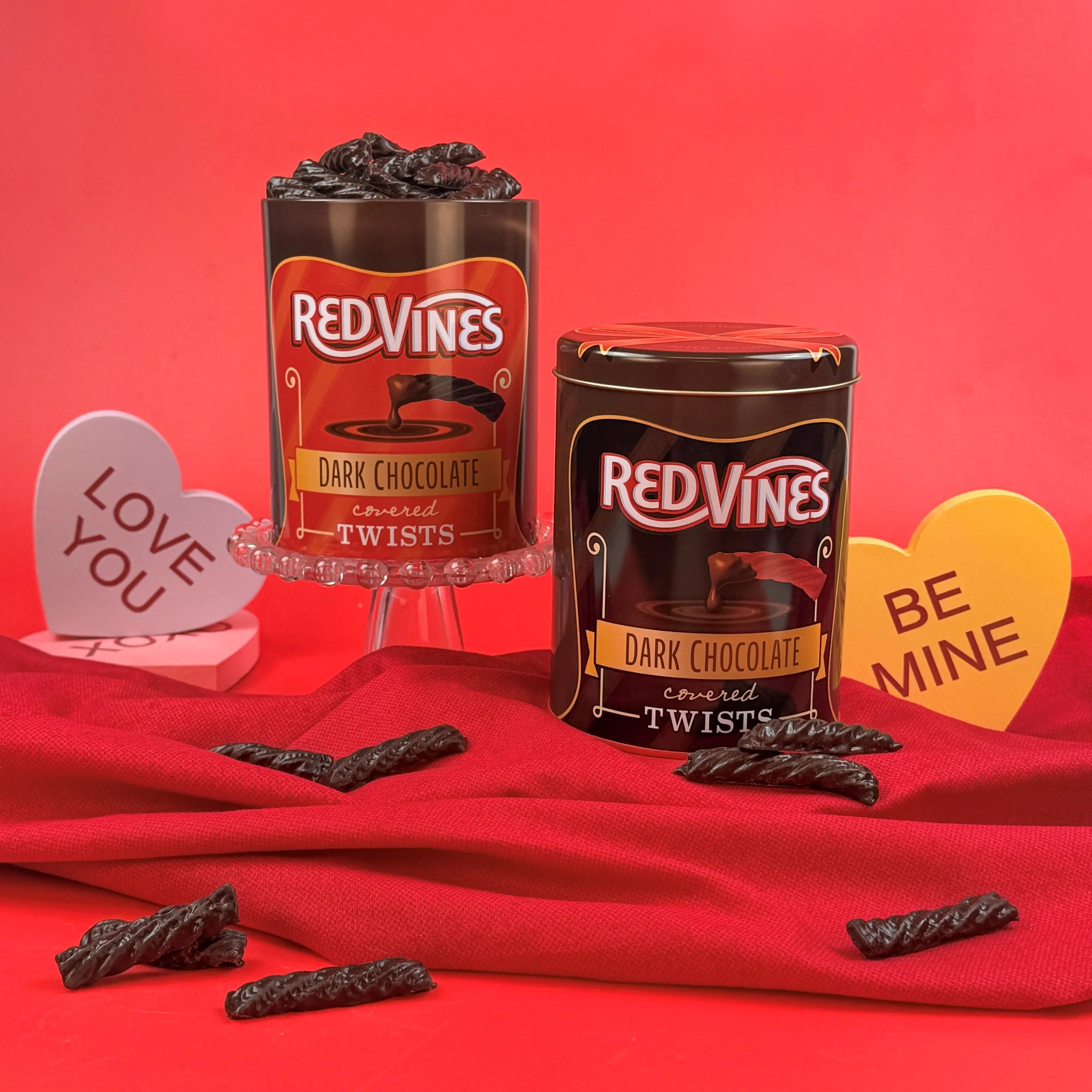 Red Vines Chocolate Covered Licorice Twists in re-usable tin, in Valentine's Day scene - Chocolate Covered Red Licorice and Chocolate Covered Black Licorice