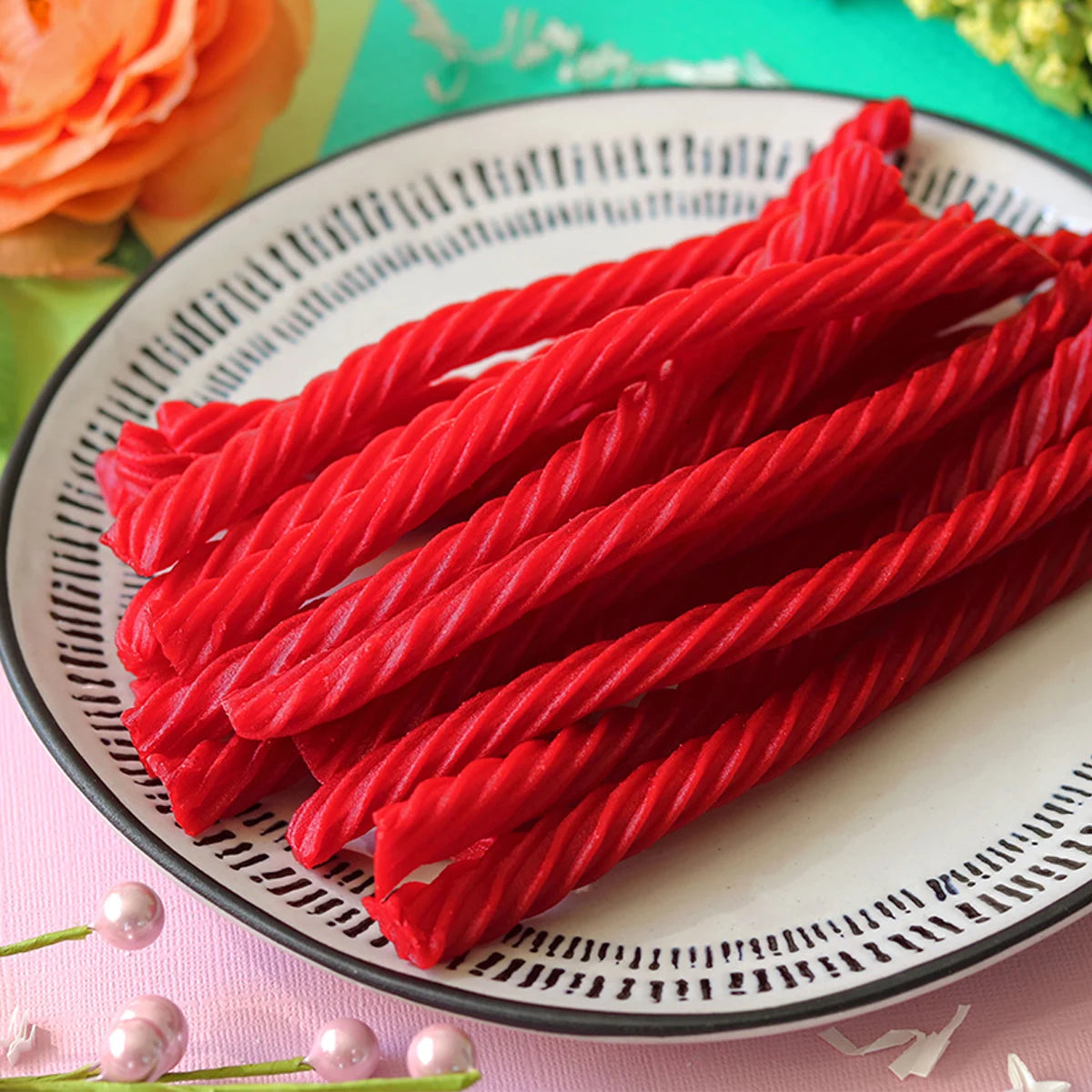 Red Vines Original Red Licorice Twists candy  in a pastel colored spring scene