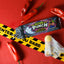 Sour Punch Ghost Pepper Roulette Novelty Candy 3.2oz Tray surrounded by caution tape and peppers