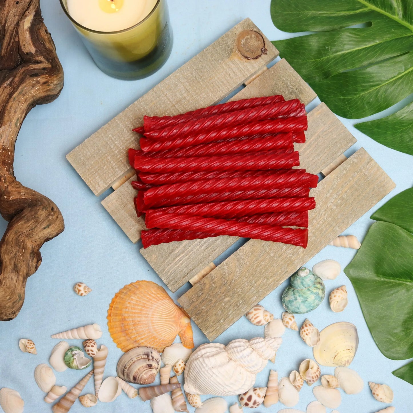 Red Vines Original Red Jumbo Twists in a summer scene with seashells and beach wood