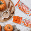 RED VINES Pumpkin Spice Halloween Candy Twists next to pumpkins, cinnamon, and chai tea