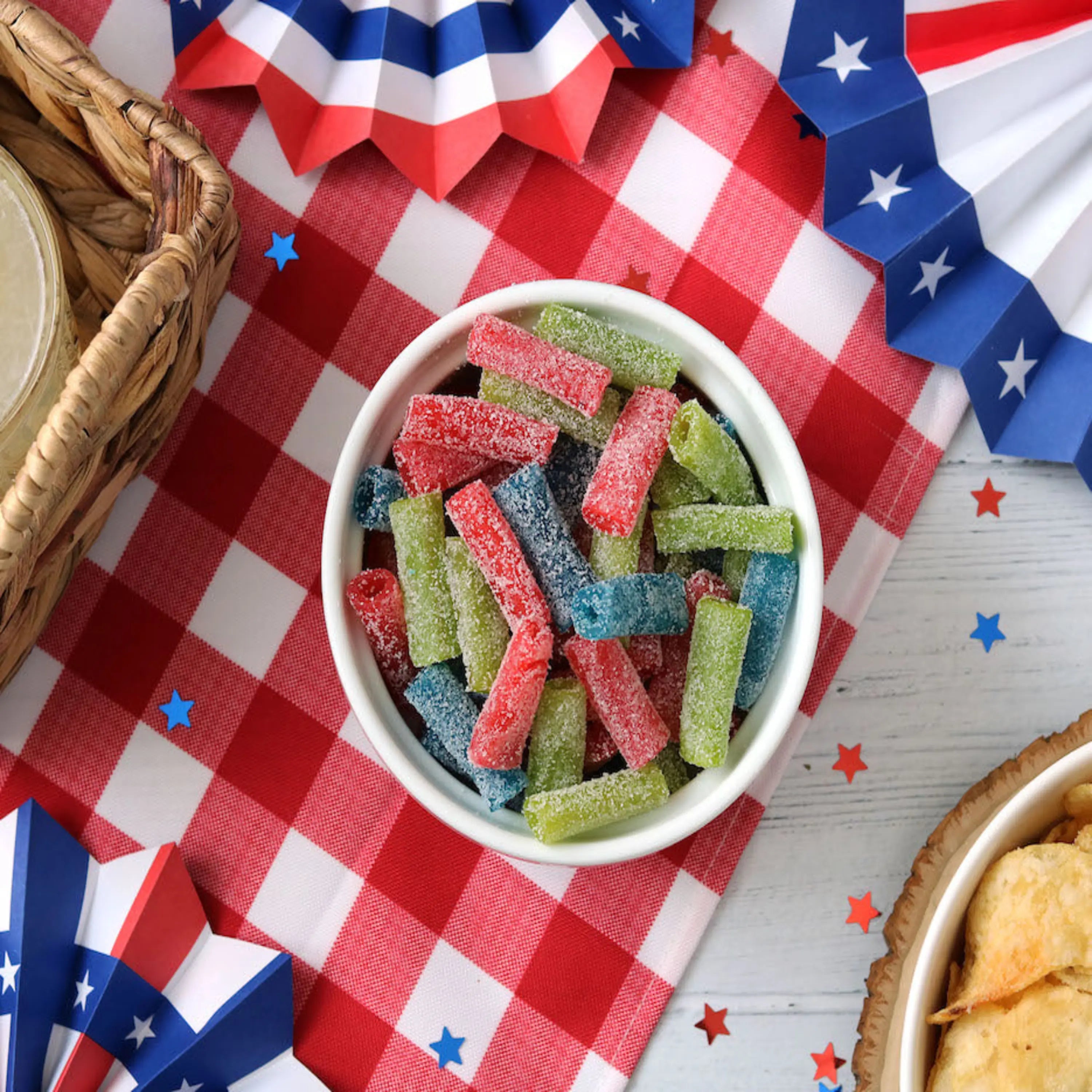 Sour Punch Bites Candy Assorted Flavors on a picnic table with patriotic decorations