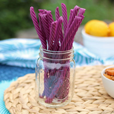 Red Vines Grape Licorice Twists in a jar near other poolside snacks