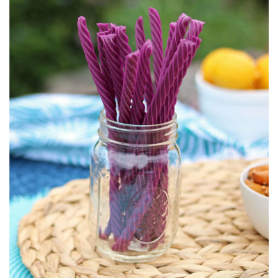 Red Vines Grape Licorice Twists in a jar near other poolside snacks