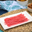 Sour Punch Strawberry Straws Candy on a platter near other poolside snacks