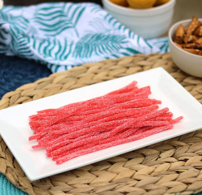 Sour Punch Strawberry Straws Candy on a platter near other poolside snacks