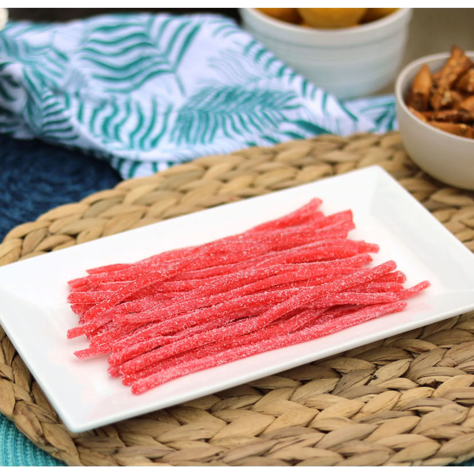 Sour Punch Strawberry Straws Candy on a platter near other poolside snacks