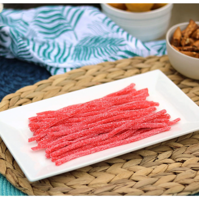 Sour Punch Strawberry Straws Candy on a platter near other poolside snacks
